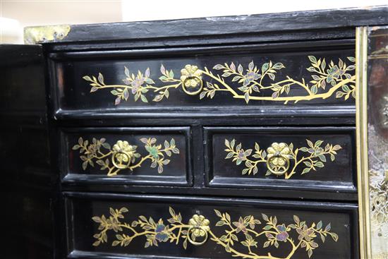 A late 17th century Chinese black lacquer cabinet, overall H. 5ft 3in.